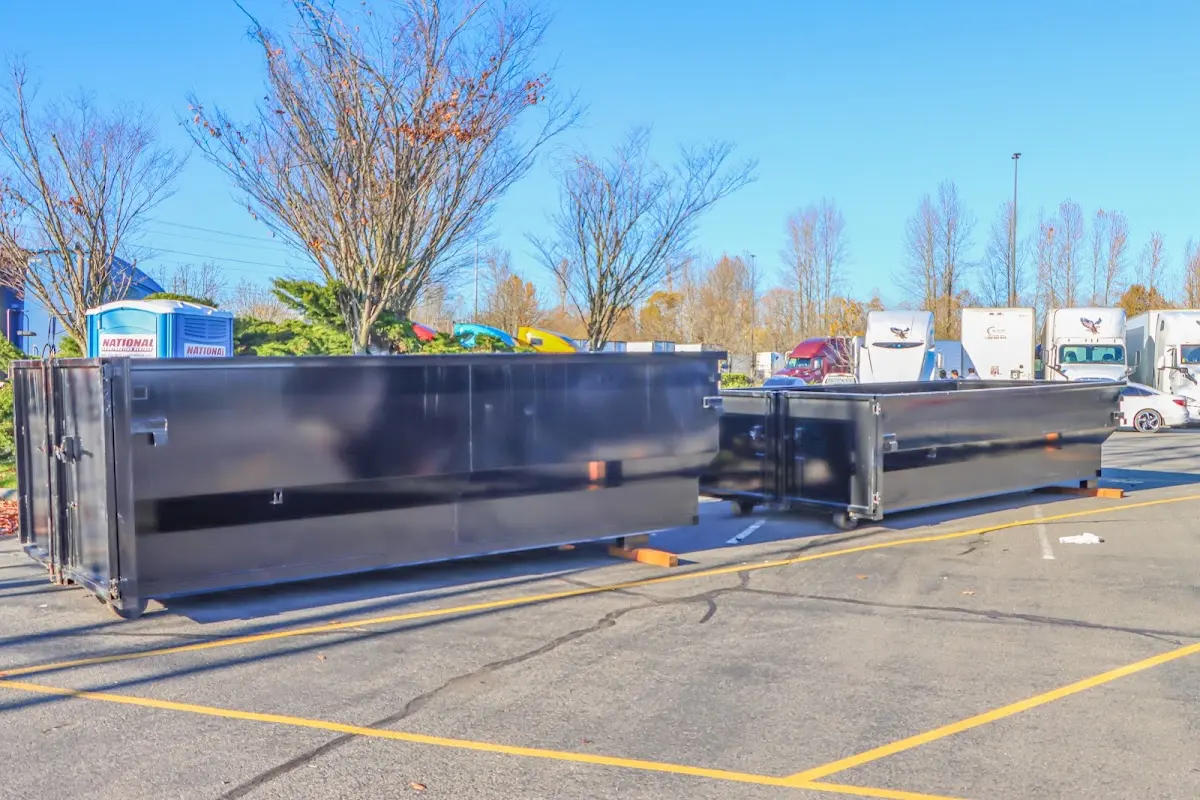 Professional dumpster rental service with roll-off container on residential driveway in Lakeville